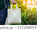 Photorealistic Image of Unbranded White Tote Bag in Outdoor Setting 137288059