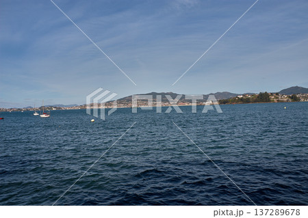 Coastal landscape of the Rias Baixas showing the blue sea and the silhouette of Panxon from the town of Baiona 137289678