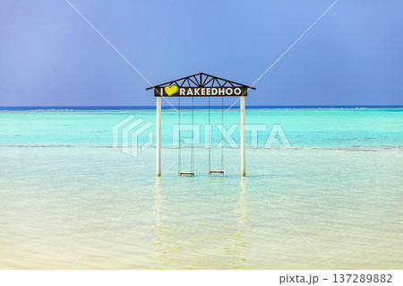 Crystal waters embrace a lone swing frame 137289882