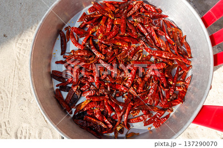 Red chilies in a metal pan, sunlit, vibrant Red chilies in a metal pan, sunlit, vibrant 137290070