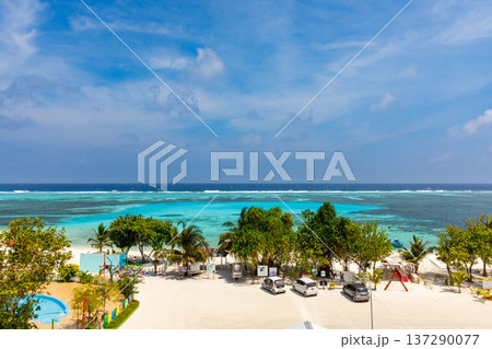 Turquoise sea meets white sand under blue sky 137290077