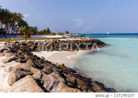 Rocky shore meets crystal-clear turquoise waters 137290107