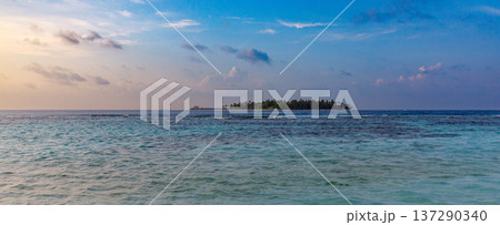 Serene island floats in turquoise waters under soft sky Serene island floats in turquoise waters under soft sky 137290340