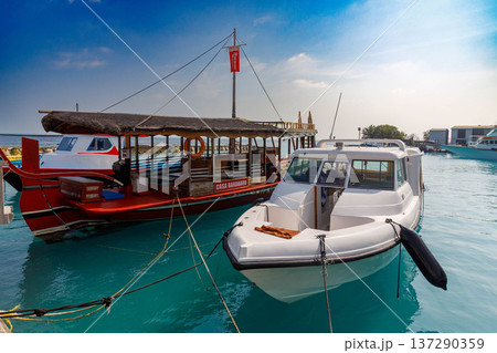 Clear turquoise water holds two boats 137290359