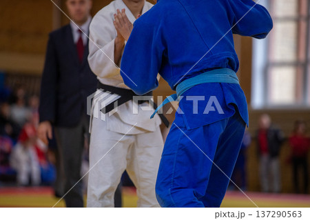 Two judo athletes facing each other Two judo athletes facing each other 137290563