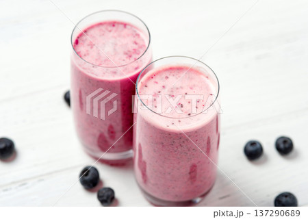Two glasses of berry smoothie with chia and fresh berries Two glasses of berry smoothie with chia and fresh berries 137290689