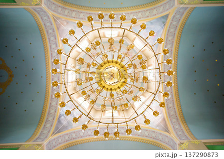 ceiling in the church with the illuminator. church lamp look from below ceiling in the church with the illuminator. church lamp look from below 137290873