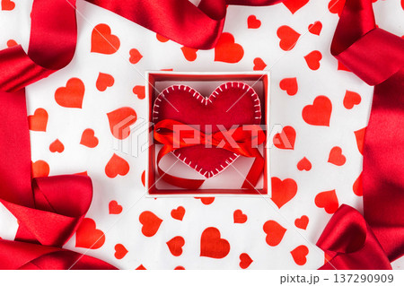 background to Valentine's Day or romantic event. heart in the gift box against the background of the hearts. 137290909