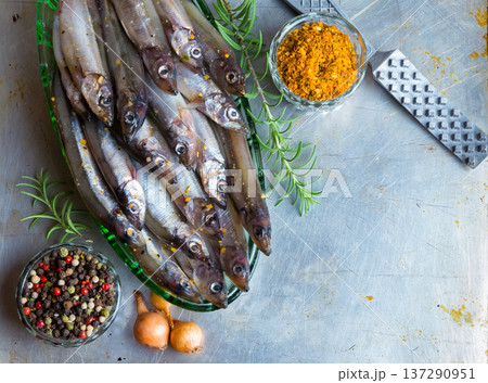 Fresh fish top view. Spicy herb and vegetables. fish and spices on a metal table. Healthy food cooking. Fresh fish top view. Spicy herb and vegetables. fish and spices on a metal table. Healthy food cooking. 137290951