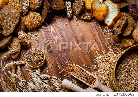 Assortment of baked bread on wooden table background 137290965