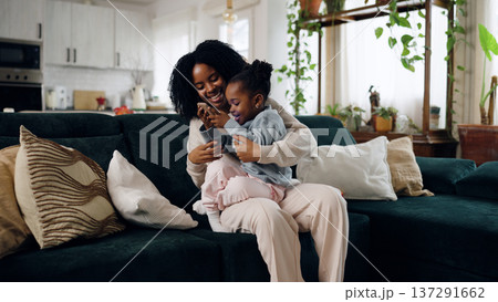 African American mother daughter bonding with smartphone African American mother daughter bonding with smartphone 137291662