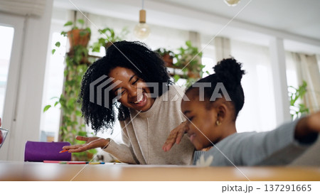 Happy mother and daughter bonding while drawing at home 137291665