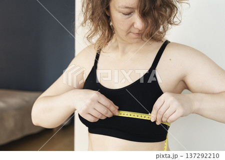 Woman measuring chest with tape for body health 137292210