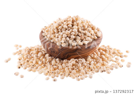 Sorghum seeds isolated on white background. Sorghum bicolor or sorgo grains in wooden bowl. Clipping path. Sorghum seeds isolated on white background. Sorghum bicolor or sorgo grains in wooden bowl. Clipping path. 137292317