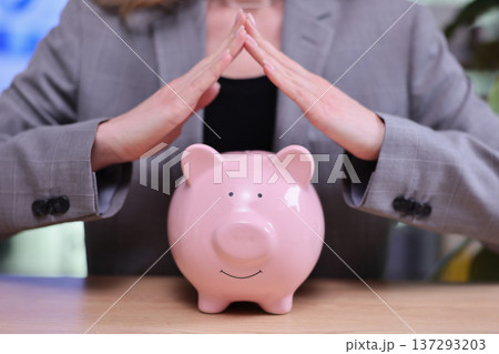Protecting savings with care during important financial planning moments in a modern office setting Protecting savings with care during important financial planning moments in a modern office setting 137293203