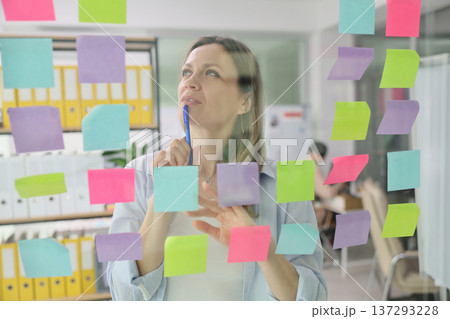 Creative brainstorming session with sticky notes in a modern office environment 137293228