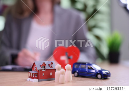Feeling secure with family, health, and a cozy home while signing important documents at a professional office setting 137293334