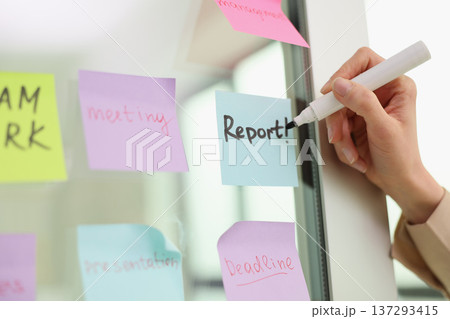 Creative brainstorming session in a modern office with colorful sticky notes for deadlines and tasks Creative brainstorming session in a modern office with colorful sticky notes for deadlines and tasks 137293415