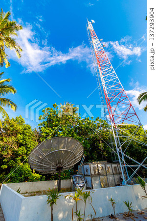 Blue sky frames tall red-and-white communication tower Blue sky frames tall red-and-white communication tower 137293904