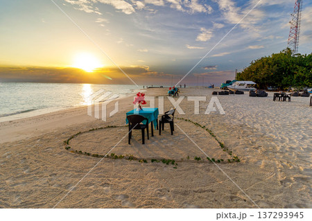 Golden sun sets over calm ocean waves 137293945