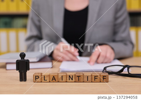 Courtroom scene captures a plaintiff preparing for a legal case with determination and focus in a professional office environment Courtroom scene captures a plaintiff preparing for a legal case with determination and focus in a professional office environment 137294058