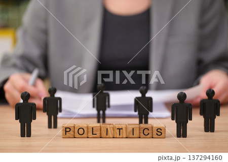 Engaging in political discussions with wooden figures representing diverse viewpoints in a formal setting 137294160
