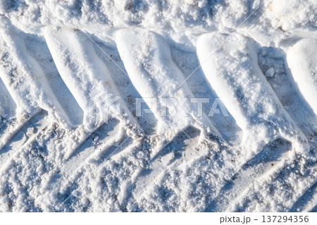 Compressed Snow Pattern With Heavy Vehicle Tire Imprints In Winter Compressed Snow Pattern With Heavy Vehicle Tire Imprints In Winter 137294356