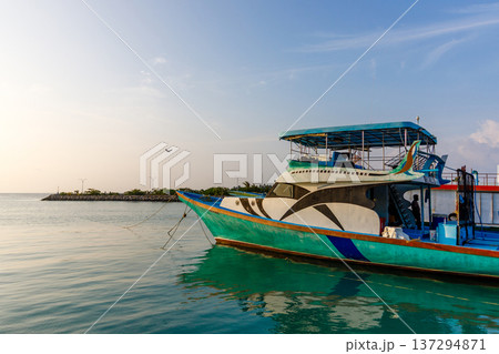 Colorful boat floats calm turquoise waters Colorful boat floats calm turquoise waters 137294871
