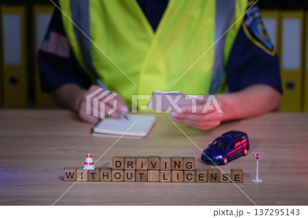 Driving under scrutiny as an officer notes important details about a traffic violation involving a toy car on a desk 137295143