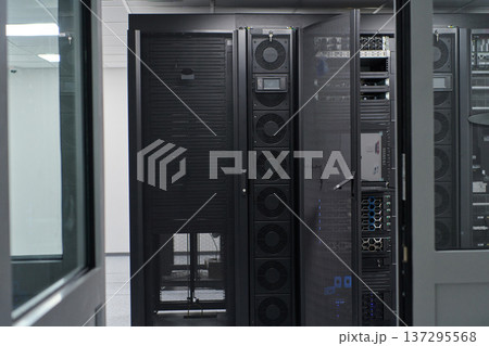 Data center server racks and network equipment in a modern IT infrastructure room for enterprise operations 137295568