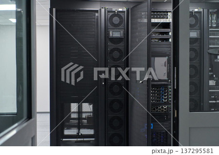 Modern data center with server racks and network equipment inside a secure IT room for enterprise infrastructure Modern data center with server racks and network equipment inside a secure IT room for enterprise infrastructure 137295581