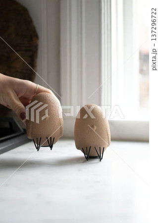 Woman Hand Holding Decorative Chicken in Eggshell Woman Hand Holding Decorative Chicken in Eggshell 137296722