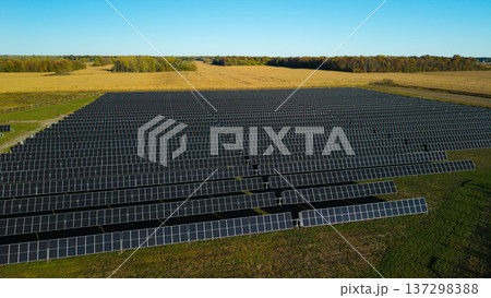 Aerial drone view of large solar power plant with rows of photovoltaic panels in rural landscape Aerial drone view of large solar power plant with rows of photovoltaic panels in rural landscape 137298388