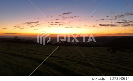 Sunrise over rural pasture landscape with rolling hills Sunrise over rural pasture landscape with rolling hills 137298614