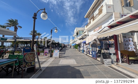 Main tourist street with restaurants and souvenir shops on both sides under the blue sky 137299294