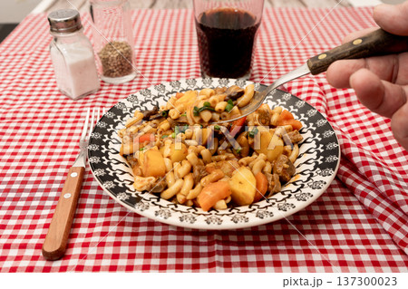 Hearty beef goulash stew with elbow macaroni pasta Hearty beef goulash stew with elbow macaroni pasta 137300023