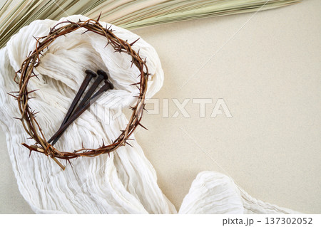 Crown of thorns, nails, cloth, palm leaf representing easter Crown of thorns, nails, cloth, palm leaf representing easter 137302052