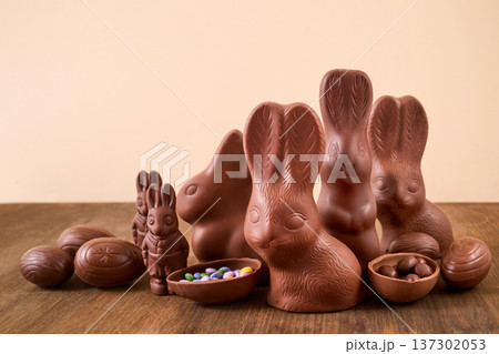 Chocolate bunnies and easter eggs on wood surface 137302053