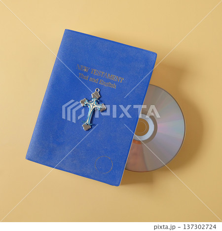 Bible book with CD rom on color background. 137302724