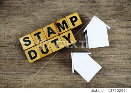 Stamp Duty alphabet letters with house model on wooden background 137302954