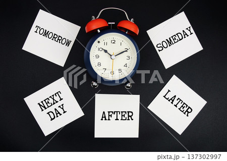 Alarm Clock Surrounded with Tomorrow, Next Day, After, Later, Someday 137302997