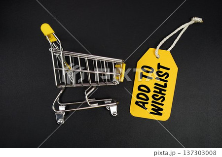 Mini Trolley Shopping Cart and price tag with message "Add To Wishlist" on black background Mini Trolley Shopping Cart and price tag with message "Add To Wishlist" on black background 137303008