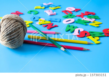 Minimalist photo of a natural jute twine with alphabet letters. 137303151