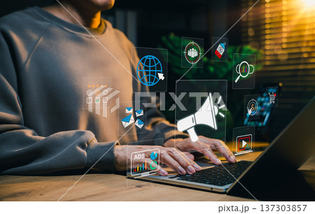 Digital marketing concept. Person working on laptop and advertising icons, representing online promotion, targeted marketing, customer engagement, data analytics, multichannel advertising strategy, Digital marketing concept. Person working on laptop and advertising icons, representing online promotion, targeted marketing, customer engagement, data analytics, multichannel advertising strategy, 137303857
