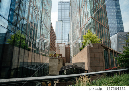 Modern glass and steel skyscrapers rising above West Chelsea in New York City. Contemporary architecture reflects the skyline and urban development of Manhattan. 137304381