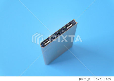 Slim power bank on color background. Slim power bank on color background. 137304389