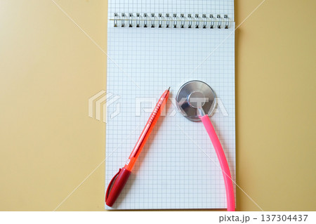 Pink Stethoscope on booknote, Medical accessories on background. Pink Stethoscope on booknote, Medical accessories on background. 137304437