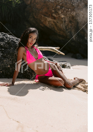 Asian woman in bikini posing on tropical beach sand, sunny vacation concept Asian woman in bikini posing on tropical beach sand, sunny vacation concept 137305173