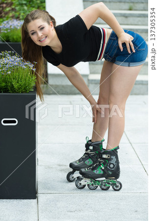 Young woman riding roller skates Young woman riding roller skates 137305354
