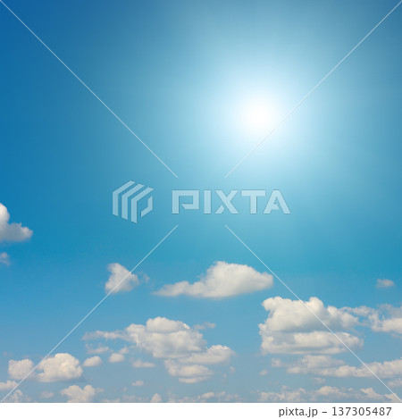 Sunny sky with glowing sunlight and fluffy white clouds on a calm weather day Sunny sky with glowing sunlight and fluffy white clouds on a calm weather day 137305487